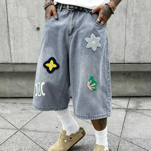 Men’s 3/4 loose denim shorts, hip-hop street style, chenille patch appliqué, wide-leg denim shorts, vintage black wash, over-the-knee length, casual skate shorts, unisex denim apparel.