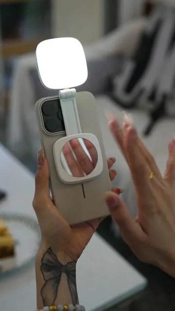A compact magnetic fill light that folds up, features a built-in mirror for selfies, and even functions as a phone stand! #lighting #selfie #selfielight #ringlight #contentcreatortools #cameraaccessories #magneticlighting #tiktokshopfinds #flashsale