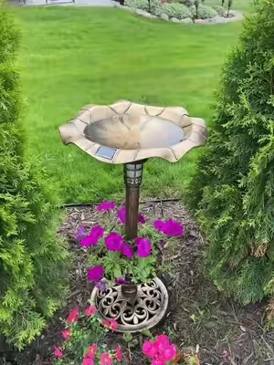 Such a beautiful, affordable addition to your yard! These are solar powered so the light is going to glow at night.  Grab one before they sell out! #birdbath #solarlight #gardendecor 