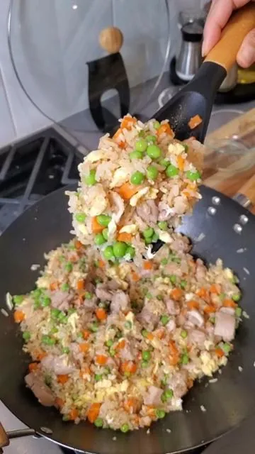 Chicken fried rice is an easy 30 minute meal. You can serve it on its own or as a side dish. You can also cook it in advance for meal prep and it's stay fresh in the fridge for 4 to 5 days. Recipe: -1 pound chicken thighs cut into bite sized pieces  -1/2 tsp salt  -1/4 tsp pepper  -3 tbsps avocado oil  -4 eggs -5 cups cooked rice  -2 tbsps soy sauce ( I used coconut aminos)  -1 1/2 tsp sesame oil  15 oz frozen peas and carrots (thawed)  -1/4 cup green onion (chopped)  Guys, I linked the BADIANO spoon in this post because it was the first time I used it. I fell in love with it and now I use it for everything! Cooking has gotten much easier with it. I find myself using it for all my meal prep meals instead of using and dirtying multiple utensils. The best thing is that it's under $10 and it has free shipping! This is a must have kitchen accessory. I only promote products that I believe in and truly make my life easier. If you love to cook, this is a great addition to your kitchen tools. Try it out for yourself. 😍 Spoon specs: -Non-toxic Materials crafted from BPA-free, food-grade silicone, ensuring the safety and purity of your cooking. -Built to withstand regular use with its durable silicone and wood construction.  -The silicone head of the spoon can be easily cleaned, making it a convenient choice for everyday cooking and serving. -The cooking spoon features an ergonomic wooden handle that provides a comfortable grip and precise control, reducing hand fatigue during prolonged use. - Includes a built-in rest to prevent the spoon head from touching the cooking surface when set down, promoting cleanliness and convenience. #kitchenmusthave  #cookware  #kitchenaccessories  #potsandpans  #kitchenutensils