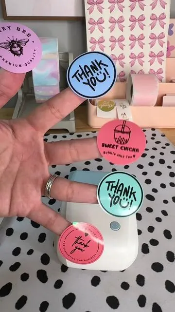 Obsessed with this little device!! 🥰🩷 They come in multiple colors too! Tap the yellow shopping bag to grab yours! #smallbusinessowner #smallbusinesstiktok #onlinebusinessowner #stickerprinter #thermalprinter 