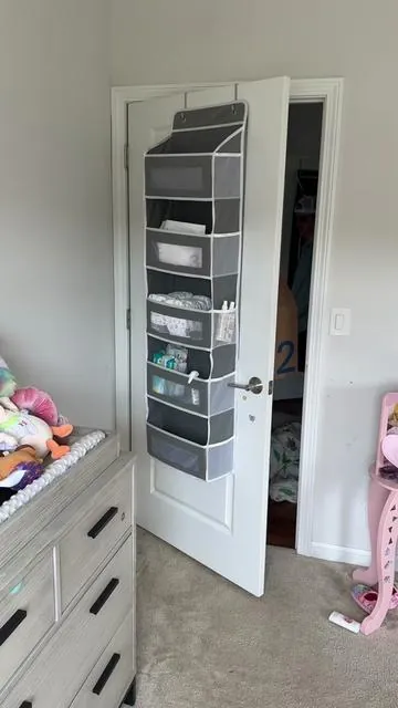 i posted about this over the door diaper storage hack over a year ag and now i can’t scroll without seeing it on someone else’s door and I LOVE IT SM y’all seriously took it and RAN and the best part is the thousands of comments saying you’re using it in bathrooms, kids’ closets, pantries, craft rooms, even RVs?? i LOVE that. it holds so much, it’s structured with flat inserts so it doesn’t sag, and it’s been one of the most useful things in our house since day one. it’s on a crazy sale right now too so don’t miss out 👀🧺 #tiktokshopblackfriday #tiktokshopcreatorpicks #tiktokshopcybermonday #homeorganization #nursery  Storage hack  Organization hack Diaper storage  Diaper organization  Diaper station  Over door hanger organizer  Apartment storage hack  Home storage hack