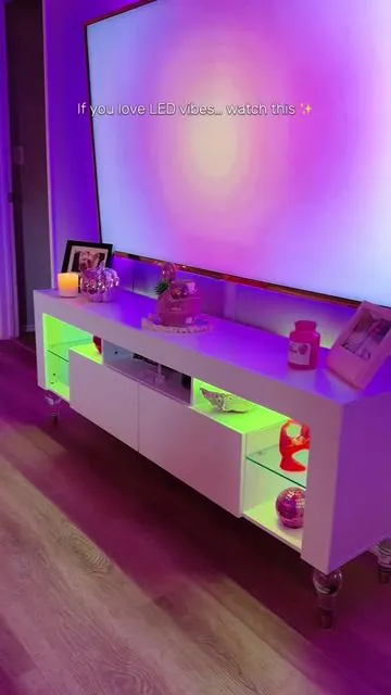 My living room has never looked this good ✨🌈 LED vibes on a budget with this custom changing TV stand that fits up to 70” TV #tvstand #livingroom #ledlights #moodlighting #livingroomfurniture 
