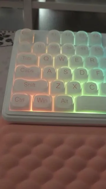 A gentle glow, a quiet click, a desk that feels a little happier ✨⌨️ The FURYCUBE IP98 sits softly in its space — 98 keys of comfort, a number pad ready for everyday moments, and a smooth little knob that turns the volume of the world down 🤍. Its foundation-style, side-engraved keycaps let the light spill through, washing the desk in dreamy RGB colors 🌈✨ Bright, playful, and calming all at once. Quiet enough for late nights, cozy enough for long days, this membrane keyboard doesn’t shout — it glows. A reminder that not everything needs to be loud to be loved 💕⌨️ If your desk needs softness, color, and calm, this one feels like home 🧸✨ @FURYCUBE Local @FURYCUBE Official Store @ZIFRIEND @ZIFRIEND LOCAL  #furycube #zifriend #keyboard #keyboardasmr  #tiktokshopholidayhauls  . . . . . . . . . . FURYCUBE IP98 keyboard • IP98 membrane keyboard • Cute keyboard aesthetic • RGB gaming keyboard • 98 key keyboard with number pad • Side engraved keycaps • Shine through keycaps • Tri-mode keyboard • Wireless office keyboard • Quiet membrane keyboard • Media knob keyboard • Gradient keycaps • Cute desk setup • Gaming and office keyboard