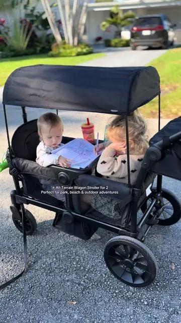 This all-terrain wagon stroller makes outings with two kids so much easier! It includes a tray table for water, eating, or playing, plus a canopy, tons of storage, and its easy to fold for on-the-go families. #WagonStroller #ToddlerEssentials #OutdoorFamily #BabyGear #MomLife