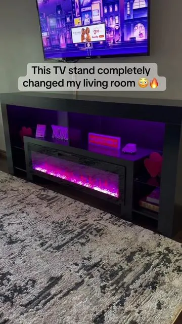 This is your sign to upgrade your living room ✨ The PUKAMI 82-inch fireplace TV stand instantly makes the space feel more modern, cozy, and elevated. I love how it combines a sleek entertainment center with a built-in electric fireplace and LED lighting. The flame effect is stunning, the storage keeps everything looking clean, and it fits large TVs while still feeling balanced in the room. It’s one of those pieces that turns your living room into the place everyone wants to sit — especially at night when the fireplace is glowing 🔥 Linked in the orange cart 🧡 #tvstand #fireplacetvstand #livingroomupgrade #homefinds #tiktokshophome 