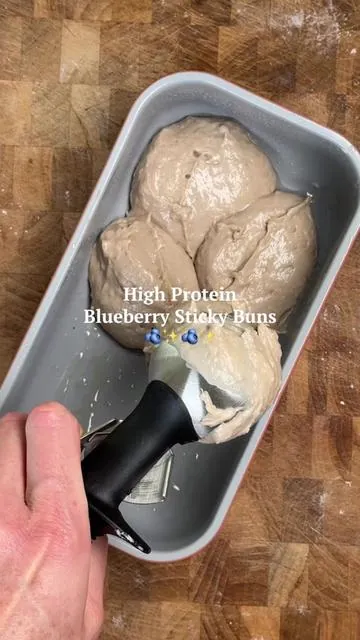 Blueberry Protein Sticky Buns 🫐 Recipe below👇 If blueberry muffins and sticky buns had a high-protein baby, this would be it. Made with @ShopFlavCity new Blueberry Muffin Protein (grab it on TT Shop!!) and guaranteed to cure a sweet tooth. Would you eat these for breakfast or dessert?  Makes 6 servings Ingredients:  ¾ cup Greek yogurt 1 egg ¼ cup maple syrup 1 cup flour 1 scoop FlavCity Blueberry Muffin Protein Smoothie 1 tsp baking powder ½ tsp baking soda Pinch of salt Coconut sugar, for dusting  Frozen or fresh blueberries  Directions: Preheat oven to 350F and spray a loaf pan with avocado oil and set aside.  In a large bowl add the Greek yogurt, egg, and maple syrup then stir to combine.  To the same bowl add the flour, FlavCity protein, baking powder, baking soda, and salt. Stir well to combine making sure to scrap down the sides of the bowl. The batter should be thick, but slightly pourable.  Allow the mixture to rest for 5 minutes.  Transfer the mixture to the prepared loaf pan using an ice cream scooper to create ‘buns’ then outline the buns with the blueberries, making sure to fill in the cracks. Top with a sprinkling of coconut sugar, then bake for 25-30 minutes until golden brown on top and a toothpick inserted in the center comes out clean.  Allow to cool for 10 minutes before serving.  Serve yourself a nice bun drizzled with maple syrup or a protein syrup (2 tbsp FlavCity Protein + 1.5 tbsp milk), and enjoy! #tiktokshopcreatorpicks #tiktokshop #protein #blueberrymuffins #proteinblueberrymuffins 