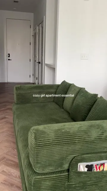 the couch of my dreams #cozy #apartmentinspo #livingroomstyle #greencouch #studioapartment 