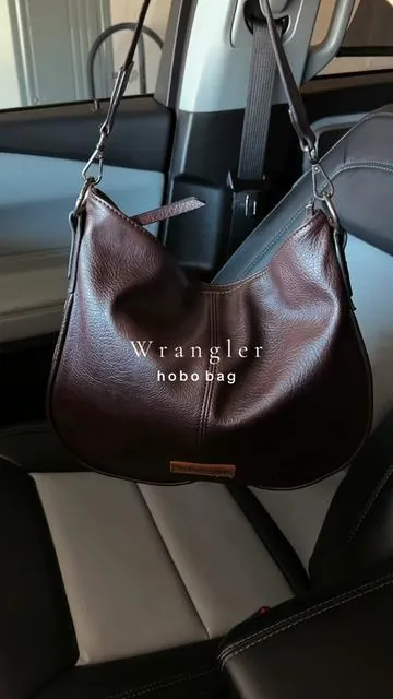 Love this bag so much 🤎 the side details! @Rustic Charm Bootic #purse #pursetok #leatherbag #wranglerpurse #hobobag 
