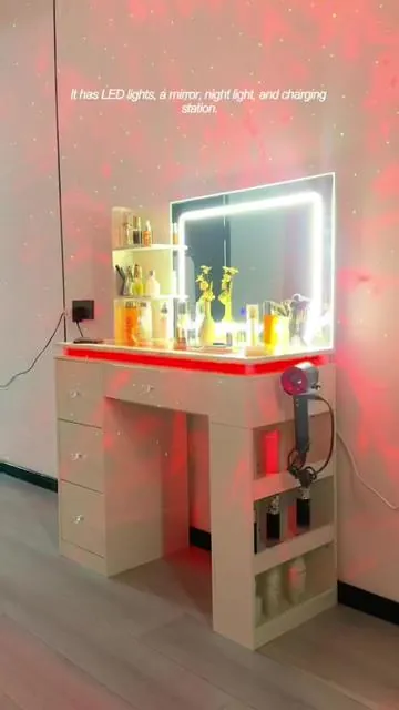 This all-in-one vanity is a game-changer! ✨ It features an LED light-up mirror, ambient night light, starry sky projection, and built-in charging station—everything you need for makeup, skincare, and relaxation in one place. With spacious drawers and open shelves, it keeps all your cosmetics, skincare, and hair tools neatly organized. The dreamy starry projection transforms your bedroom into a cozy, romantic space. It’s not just a vanity, it’s the ultimate aesthetic upgrade for renters and beauty lovers! Keywords: multifunctional vanity table, LED lighted makeup vanity, starry sky projection vanity, vanity with charging ports, ambient bedroom furniture, large storage makeup desk, aesthetic vanity desk, smart vanity table, modern white vanity, rental must-have