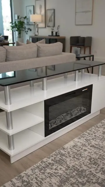 Level up your living room with a TV stand that offers both style and comfort! ✨ This 70-inch console fits TVs up to 80 inches and features a beautiful 36'' electric fireplace for that perfect cozy ambiance. Comes with a remote for easy control. Get ready to transform your space into the ultimate entertainment hub. Tap to shop this modern wooden design! #fireplacetvstand #entertainmentcenter #livingroomdecor #modernhome #AIGC #Moras
