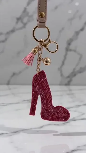 Elevate your keys or bag with a touch of glamour! ✨ This high heels rhinestone tassel keychain brings serious style with its vibrant pink glitter and elegant gold tone hardware. It's the perfect little shoe charm to express your personality. Don't miss out on this dazzling accessory. Tap to shop now! #musthave #keychainstyle #pinkglitter #rhinestonecharm #AIGC #Moras