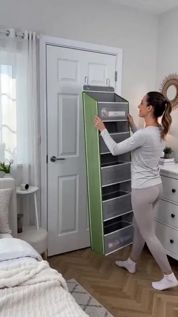 Tired of clutter taking over your room? 😩 This Over-the-Door Hanging Storage Box is your ultimate secret weapon for a tidy space! With 4 tiers and large pockets, it's perfect for organizing everything from toiletries to snacks in your bedroom, bathroom, or pantry. Get ready to reclaim your space with this compact, functional, and sturdy solution. ✨ Shop now and transform your home! #homeorganization #spacesaving #doorstorage #pantryhacks #AIGC #Moras