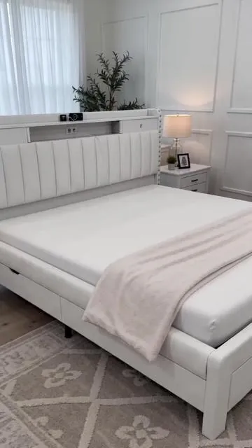 Upgrade your sleep space with the TryLazy Upholstered Flatform Bed Frame! 🛏️ This queen-size bed frame features 4 convenient storage drawers to help you keep your room tidy. Engineered for stability with wood slats that hold up to 900lbs and a no-noise rivet design for undisturbed rest. Keep your devices charged with the integrated USB socket. Its elegant white upholstery adds a modern touch. (Mattress not included). Shop now for smart storage and stylish comfort! #bedframe #bedroomgoals #storagesolutions #queensizebed #AIGC #Moras