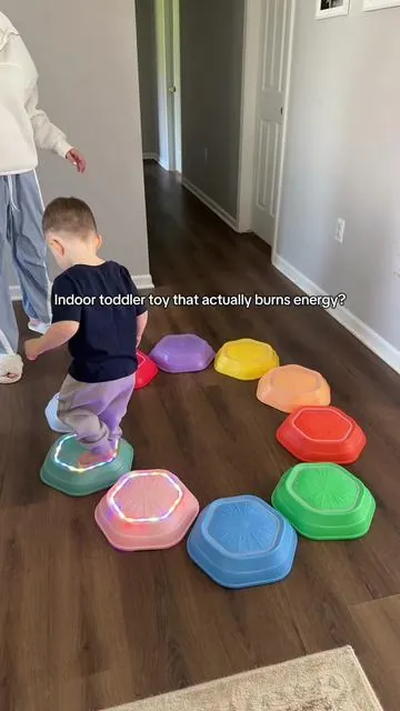 These musical stepping stones have been one of our favorite indoor activities lately. Great for movement, balance, coordination, color learning, and getting toddler energy OUT indoors. #montessoritoddler #toddleractivities #toddlertoys #learningthroughplay #grossmotorskills 