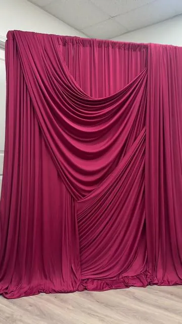 This dramatic Baroque-inspired backdrop was created with just 3 things: drapes, a backdrop stand, and a stitch gun. Super easy to recreate and absolutely stunning for weddings and events.  Tap the link above my name to shop the drapes today. #weddingdecor #eventdecor #luxurydecor #draping #backdropdesign 