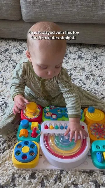 He is never this interested in a toy for this long! This busy board is so colorful and a perfect screen-free activity for babies and toddlers. #babytoy #toddlertoy #busyboard  #summerwins #dealsforyoudays 