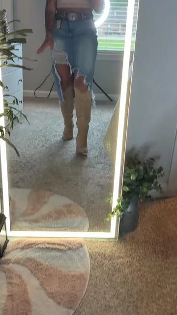 This skirt had me at the asymmetrical hem. 😍 The distressed details, front slit, and western vibe make it perfect for concerts, rodeos, date nights, girls’ trips, or just because you want to look cute. Pair it with boots, a graphic tee, or your favorite tank and you’re ready to go. And can we talk about how good it looks with cowboy boots? 🤠🔥 ✨ Limited-time offer available now. #westernstyle #denimskirts #distresseddenim #SummerVibes #dealsforyourdays 