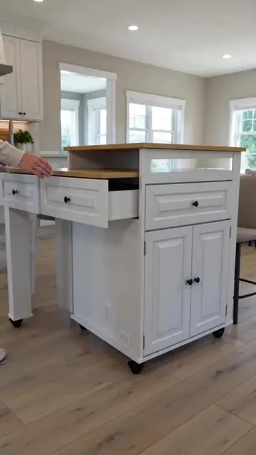 Maximize your kitchen space with this versatile extendable island! It glides from 48 to 80 inches, adapting to your needs and doubling as an extended dining table. Keep devices powered up with the integrated power outlet. Features 2 storage drawers and 3 open shelves for convenient organization, all on smooth-rolling wheels. Choose from white, black, brown, or blue to match your home style. Tap to shop and enhance your kitchen functionality today! #kitchenisland #storagesolution #DealsForYouDays #AIGC #Moras