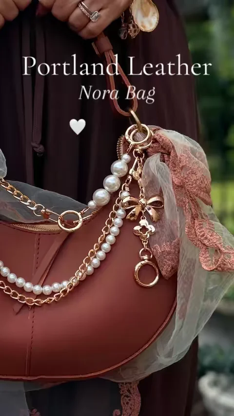 Finding your personality in your accessories doesn't have to be hard! Creating a bag that's completely you and one of a kind is the perfect way to show off your individual style. I don't want a bag everyone else has — I want something uniquely me! Dressing up my Nora bag from Portland Leather truly felt like I was creating something I genuinely love!  #NoraBag #PortlandLeather #BagInspo #bagcharms #HowToStyleYourBag