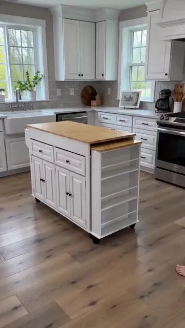 Need to maximize your kitchen space? This extendable kitchen island is here to help! ✨ It expands from 48" to a generous 80" and includes an extended dining table for extra utility. Super convenient with a built-in power outlet! 🔌 Keep everything tidy thanks to 2 storage drawers and 3 rows of open shelves. Plus, it's a mobile cart, so you can easily roll it wherever you need it. Choose from white, black, brown, or blue to match your home. Ready for a smarter kitchen? Tap to shop now! #fyp #kitchenisland #DealsForYouDays #AIGC #Moras