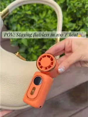 POV: Every girl needs this mini fan in her bag. 👛👜🥵Say goodbye to a sticky face this summer. 👋🩷💛🧡 #makeuphacks #sweatproof #bagessentials #minifan #summeressentials 