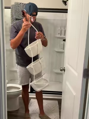 Small bathroom? This over-the-door woven basket organizer gives you three extra tiers of storage without drilling a single hole. Perfect for toiletries, skincare, hair products, or nursery essentials..and it adds that cozy, high-end look at the same time.  #BathroomOrganization #HomeOrganization #StorageHacks #BathroomDecor       