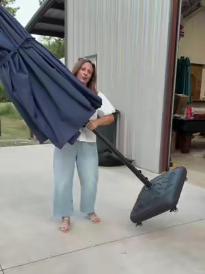 Keep your patio umbrella exactly where you want it without all the heavy lifting. This rolling umbrella base makes moving it around quick and easy. #PatioFurniture #OutdoorLiving #BackyardSetup #UmbrellaStand #HomeIdeas 