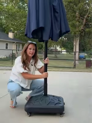 Roll your shade exactly where you need it. This rolling umbrella stand makes moving your patio umbrella quick and effortless. #PatioSetup #OutdoorLiving #BackyardIdeas #PatioFurniture #OutdoorDecor 
