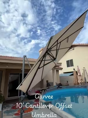 Full 360° shade and built-in solar lights? Say less. Beat the summer heat and elevate your outdoor space with the Garvee 10ft Cantilever Patio Umbrella!  Built to last, this heavy-duty offset sun shade features a rustproof aluminum frame and a durable, waterproof 600D Oxford canopy that holds up against wind and rain. Never worry about moving heavy patio furniture again—the smooth 360-degree rotating design and adjustable tilt let you direct full shade exactly where you need it as the sun moves across the sky. When night falls, turn on the built-in solar-powered LED rib lights to create a warm, cozy atmosphere for poolside relaxing or evening chats on the patio. #offsetumbrella #cantileverumbrella #umbrella #patioumbrella #tiktokshopcreatorpicks 