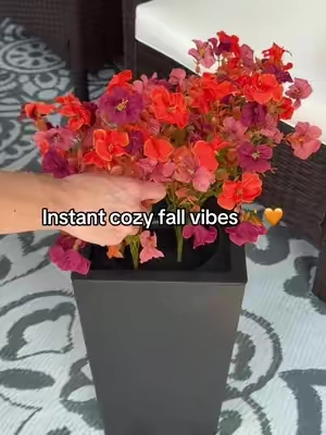 Cozy fall porch vibes without the upkeep 🍂🧡 These artificial fall flowers come in a set of two black planters and give your front porch, patio, entryway, or garage that full autumn look without watering or replacing real flowers. Such an easy way to bring warm seasonal color outside for fall. #FallDecor #FallPorchDecor #ArtificialFlowers #OutdoorFallDecor #fauxflowers artificial fall flowers fall flowers for porch outdoor artificial flowers fall porch planters autumn floral arrangements front porch fall decor faux fall flowers