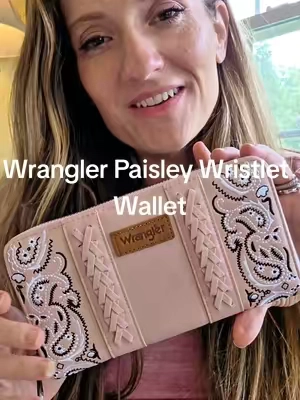 A roomy Wrangler PU leather wallet with embroidered paisley details, whipstitch accents, multiple compartments, a zipper pocket, ten card slots, and a wrist strap. #WranglerWallet #WomensWallet #WristletWallet #PaisleyWallet #Wrangler @Vaqueras Outfitters 