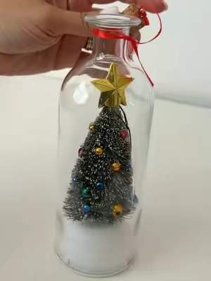 A voice recording saved in a Christmas bottle is such a special keepsake 🥺🎄 Featuring a charming snowy tree scene inside a clear glass bottle, this recordable ornament lets you preserve a heartfelt holiday message from someone you love forever. #christmasornament #holidaykeepsake #meaningfulgifts #christmasgiftideas #sentimentaldecor 
